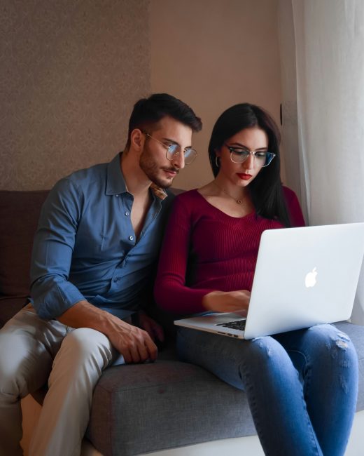 Man and woman looking at a computer