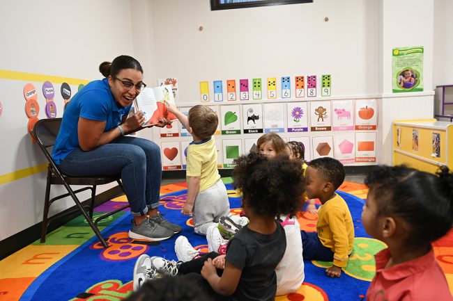 teacher reading a book to preschoolers